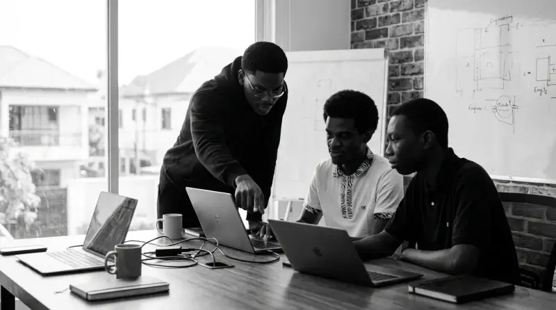 Franklin, Kwabena and Samuel of Afrokan Labs working together at laptops